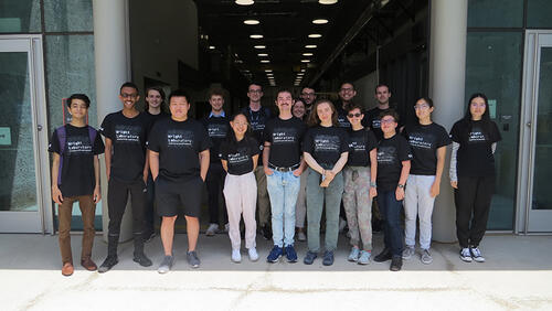 Group of people standing in a group with Wright Lab t-shirts on.