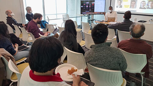 person sitting giving presentation to audience.