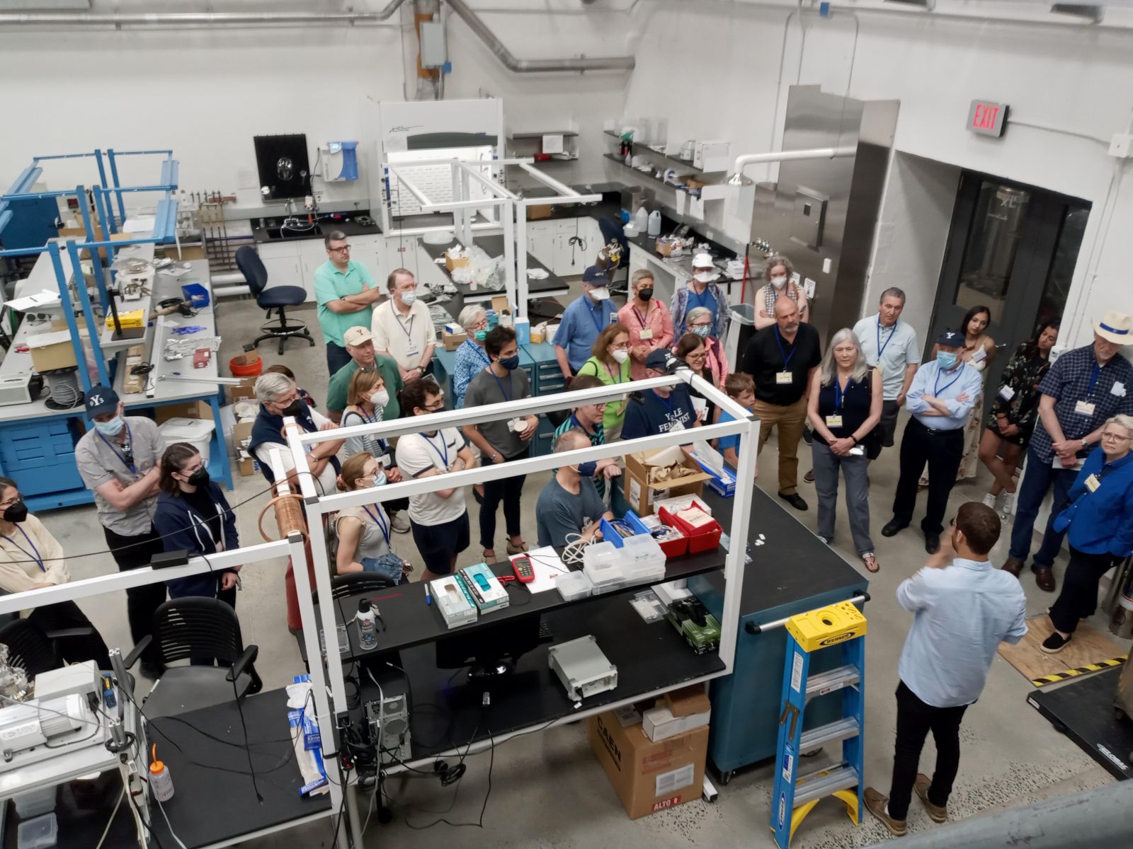 a large group of people standing in a lab.