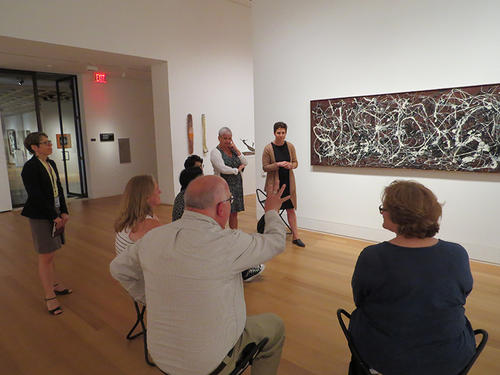 people sitting in front of Jackson Pollock painting