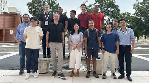 group of people standing and smiling.