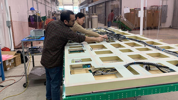 Two people working on a large CRP.