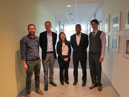 thesis committee members standing in hallway