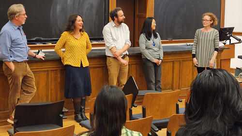 Five people standing in front of a classroom.