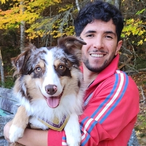 Eduardo Castro Munoz holding a dog.