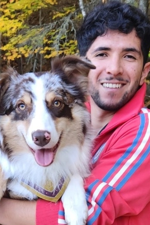 Eduardo Castro Munoz holding a dog.