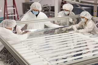 Four people working on PROSPECT experiment in Wright Lab clean room.
