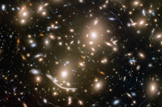 A field of brightly shining galaxies against a black background.