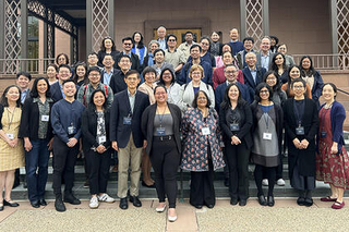Group of Asian Americans and STEM Conference 2024 attendees in front of steps outside a building.