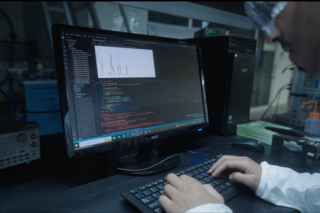 Closeup of person using a computer at Wright Lab.