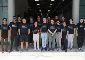 Group of people standing in a group with Wright Lab t-shirts on.