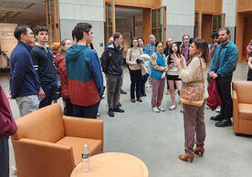 people standing in a group listening to a guide.