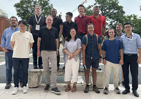 group of people standing and smiling.