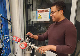 Tyler Johnson working on an instrument for the RAY experiment.