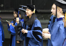 happy graduating students in cap and gown.