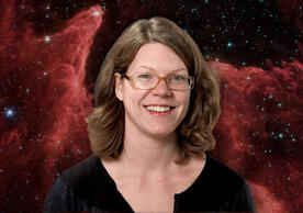 headshot with astronomical imagery in background.