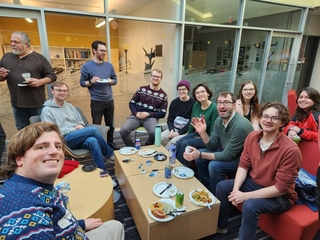 Group of people smiling at the Wright Lab winter celebration.