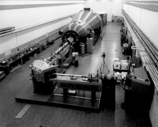 long tank in long room with rails on walls.