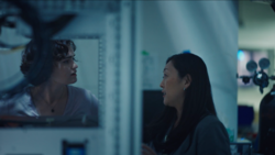 Close-up image of two scientists talking in a lab at Wright Lab.