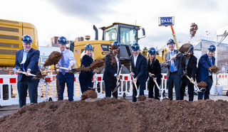 Line of people in hard hats and shovels at Yale Upper Science Hill groundbreaking ceremony.