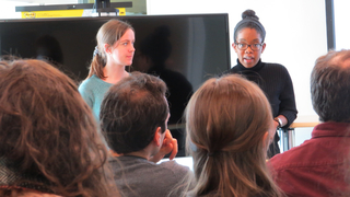 Close up of Wright Lab grad student and postdoc giving talk in front of audience.