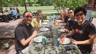 People smiling while eating pizza