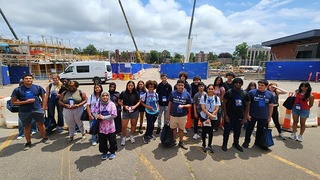 Group of Pathways students standing outside in front of Wright Lab construction site.