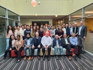 Large group of people in ALPHA Collaboration sitting/standing and posing at Wright Lab.