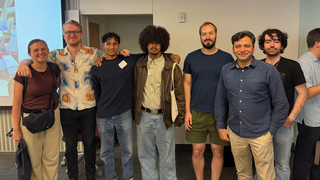 Seven people in Wright Lab Relativistic Heavy Ion Group posing for picture at final Pathways symposium.