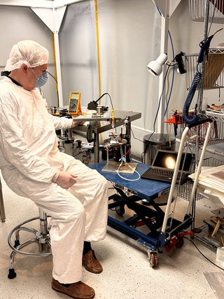 Nikolai Smirnov in clean room garb inside lab at Wright Lab.
