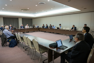Talia Weiss and the rest of the working group members seated at a conference table.