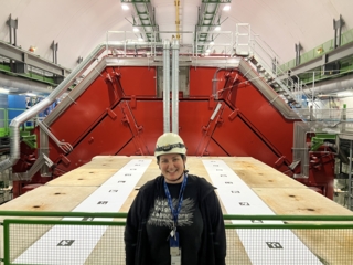 Wright Lab graduate student Sierra Cantway in front of ALICE detector at CERN.