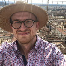 Man with hat. Taking a picture of himself on a rooftop.