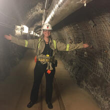 picture of scientis in tunnel with hard hat.