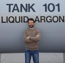 person standing in front of liquid argon tank.
