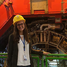 person in hard hat standing by experiment equipment.