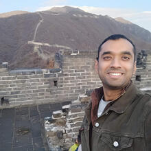 Person standing in front of wall.