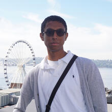 headshot of person in front of ferris wheel in background.