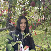 headshot in front of apple tree.